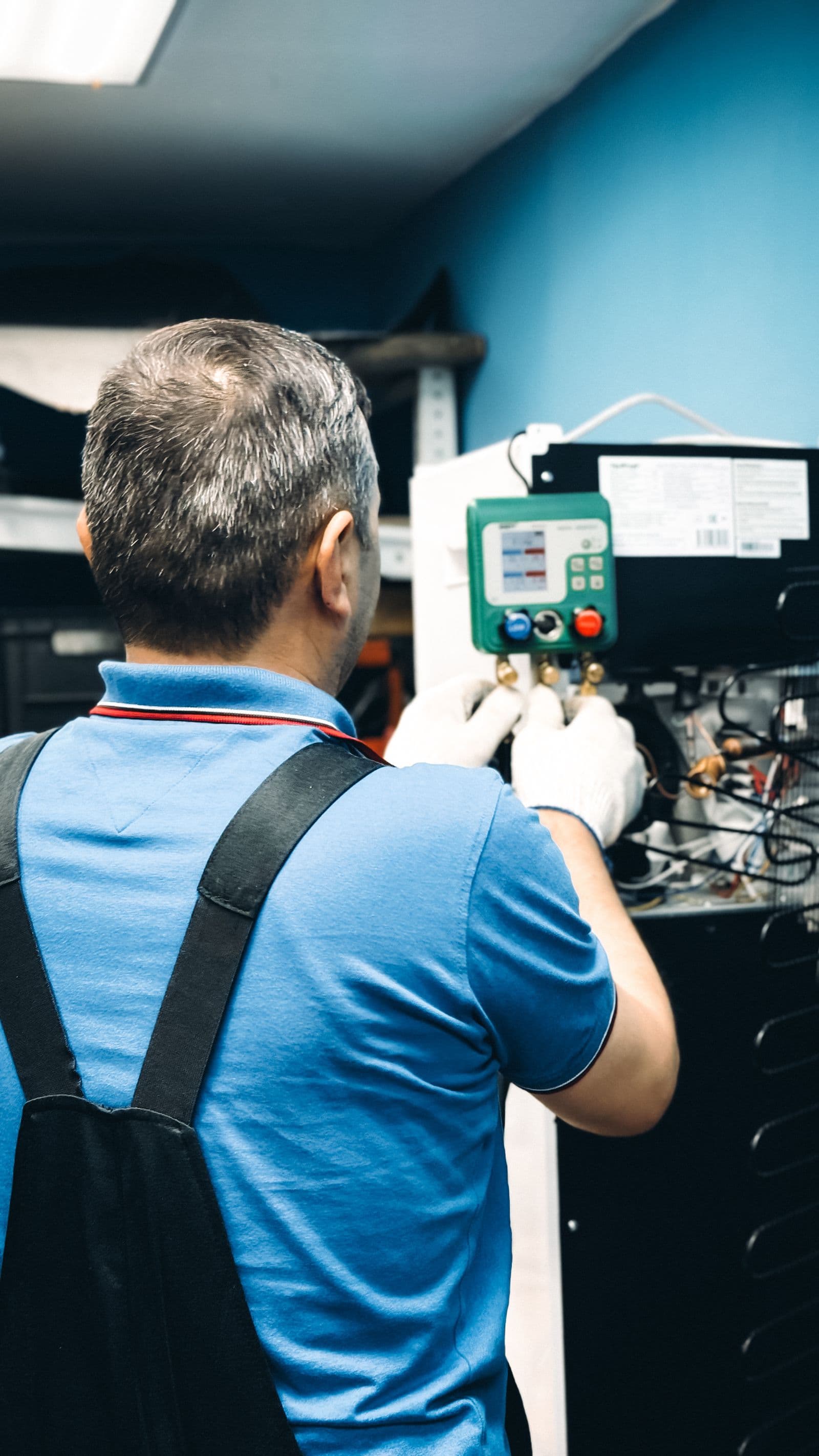 Técnico realizando manutenção em ar-condicionado (foto ilustrativa)